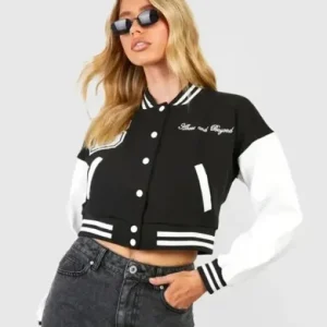 Above and Beyond Crop Varsity Jacket with a trendy cropped silhouette, contrast sleeves, snap-button front, ribbed trim, and bold “Above and Beyond” lettering for a sporty, street-style statement.