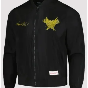 Model wearing the Bruce Lee Celebrating 50 Years bomber jacket; features a sleek black satin finish, embroidered Bruce Lee anniversary graphics, ribbed cuffs and hem, and a classic varsity silhouette honoring the martial arts legend.